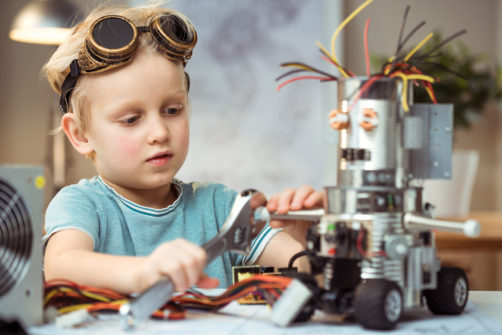 Little boy making robot